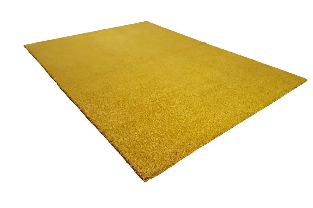 Mustard-yellow Gabbeh rug, corner view in triangular perspective