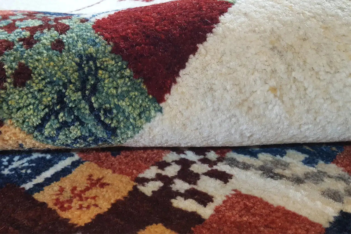 Carpet detail: multicolored patchwork areas with a woven texture on a beige background