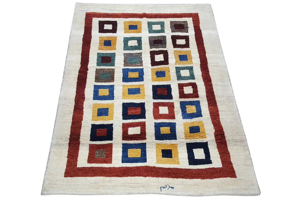 Gabbeh rug with a rectangular pattern: cream background, red border, colorful squares