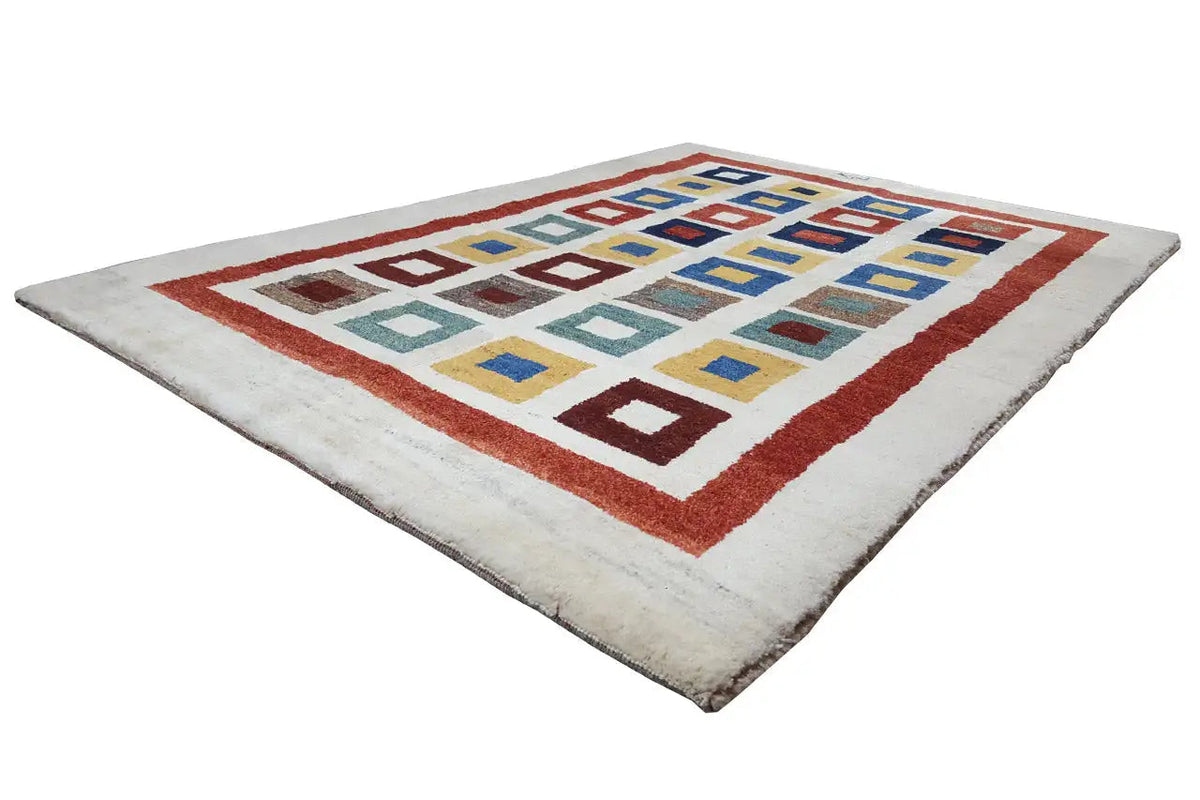 Gabbeh rug with a red border and colorful squares on a light background, one corner slightly rounded