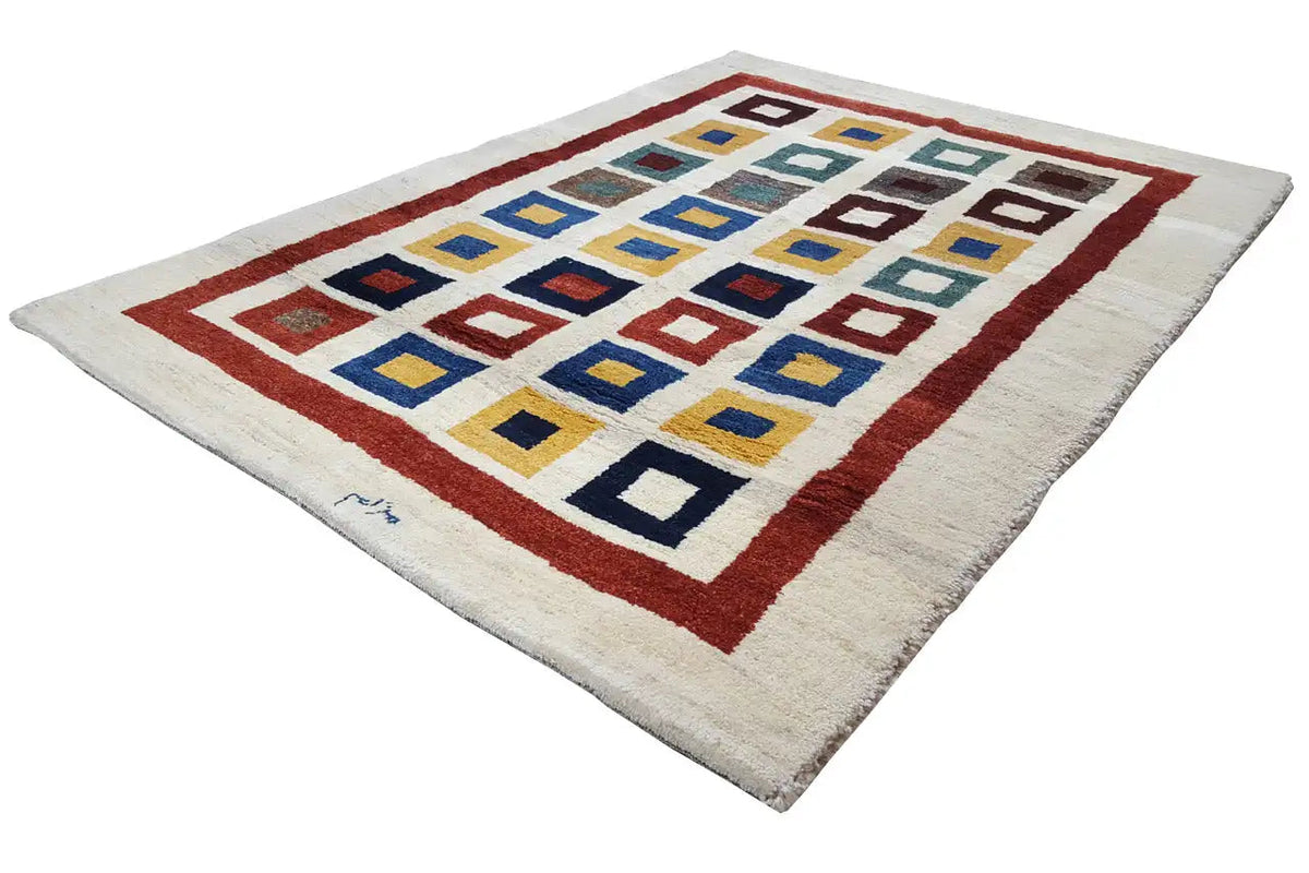 Gabbeh rug with a red border and a grid of colorful quadrilaterals on a light background