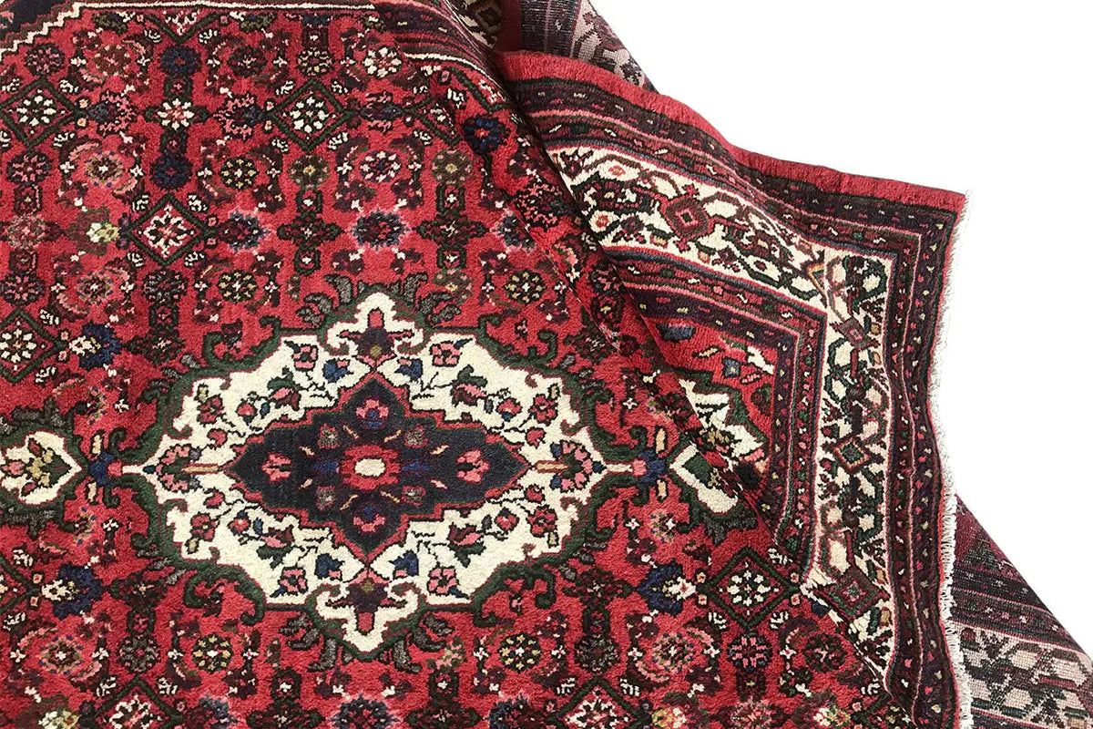Carpet detail on the border with a red background and multicolored ornamental frame
