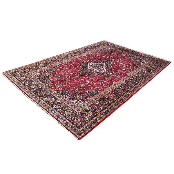 Red Keshan rug with a dark border pattern and floral ornaments
