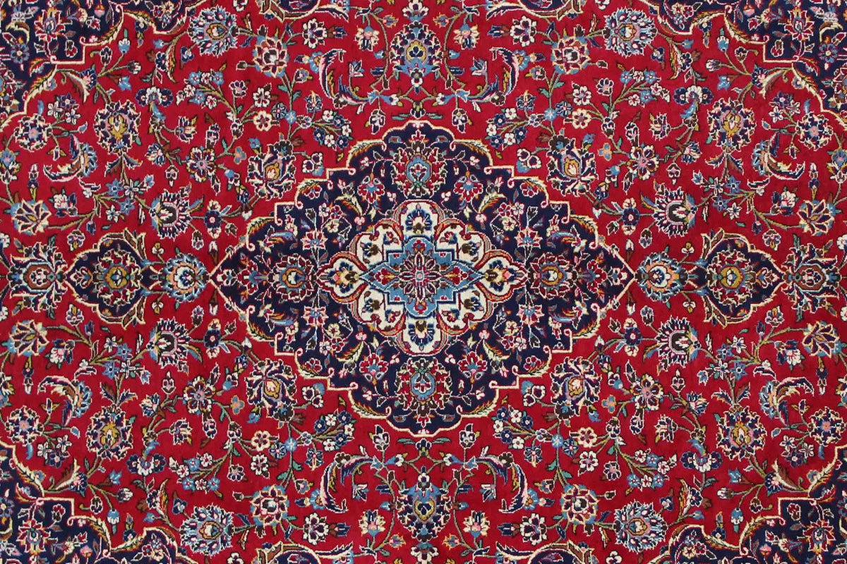 Close-up of a carpet pattern: red background with blue and gold floral ornaments