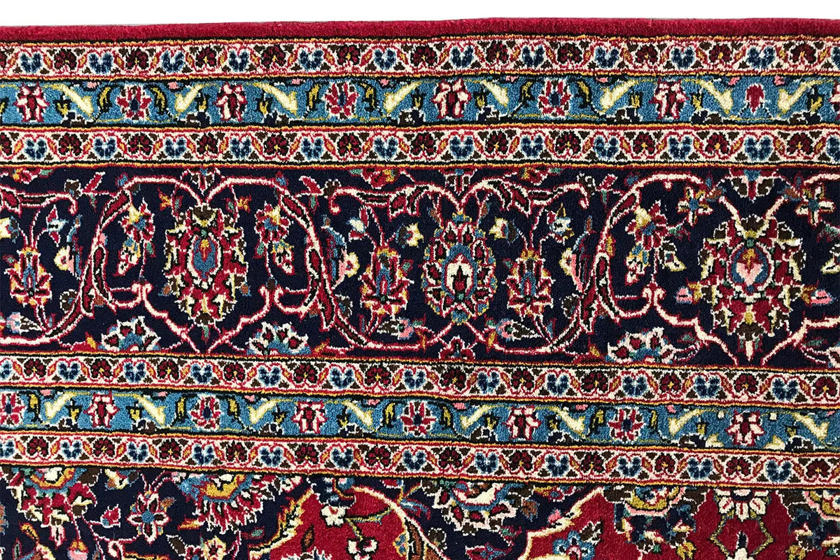 Border view of carpet: dark blue background with red, green, and gold vines