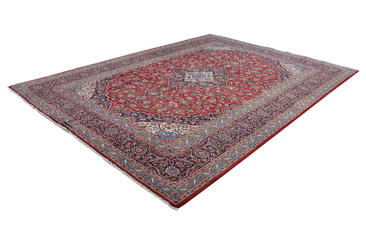 Keshan rug with a red center and ornate border, rectangular (diagonal).