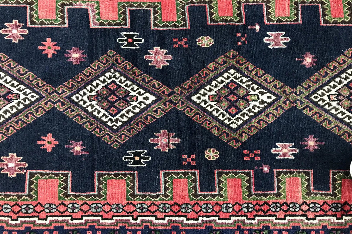Sirjan runner detail: dark blue area with a cross and diamond pattern in red, green, and beige