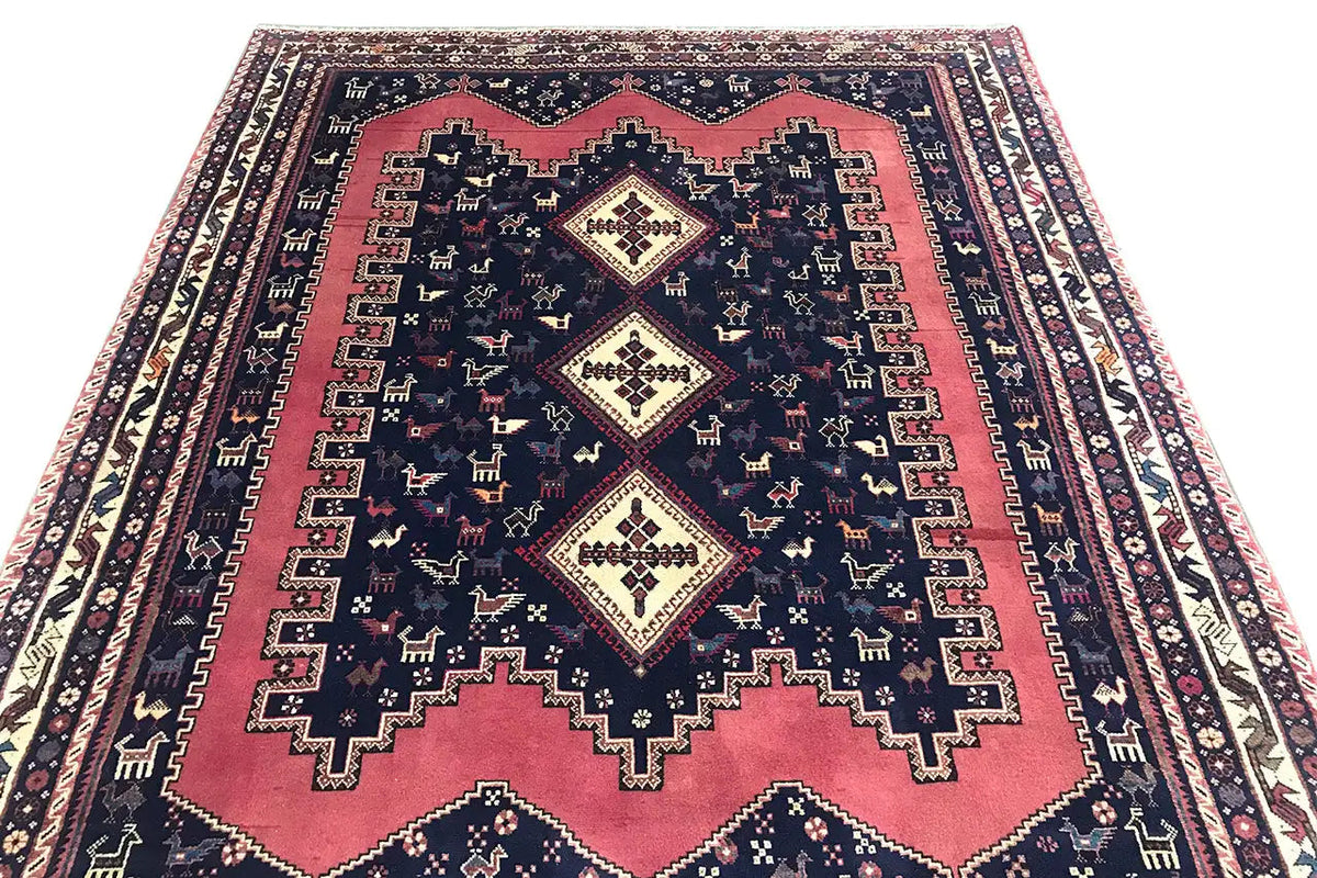 Oriental rug with central diamond motifs: dark blue, red, and cream-colored details