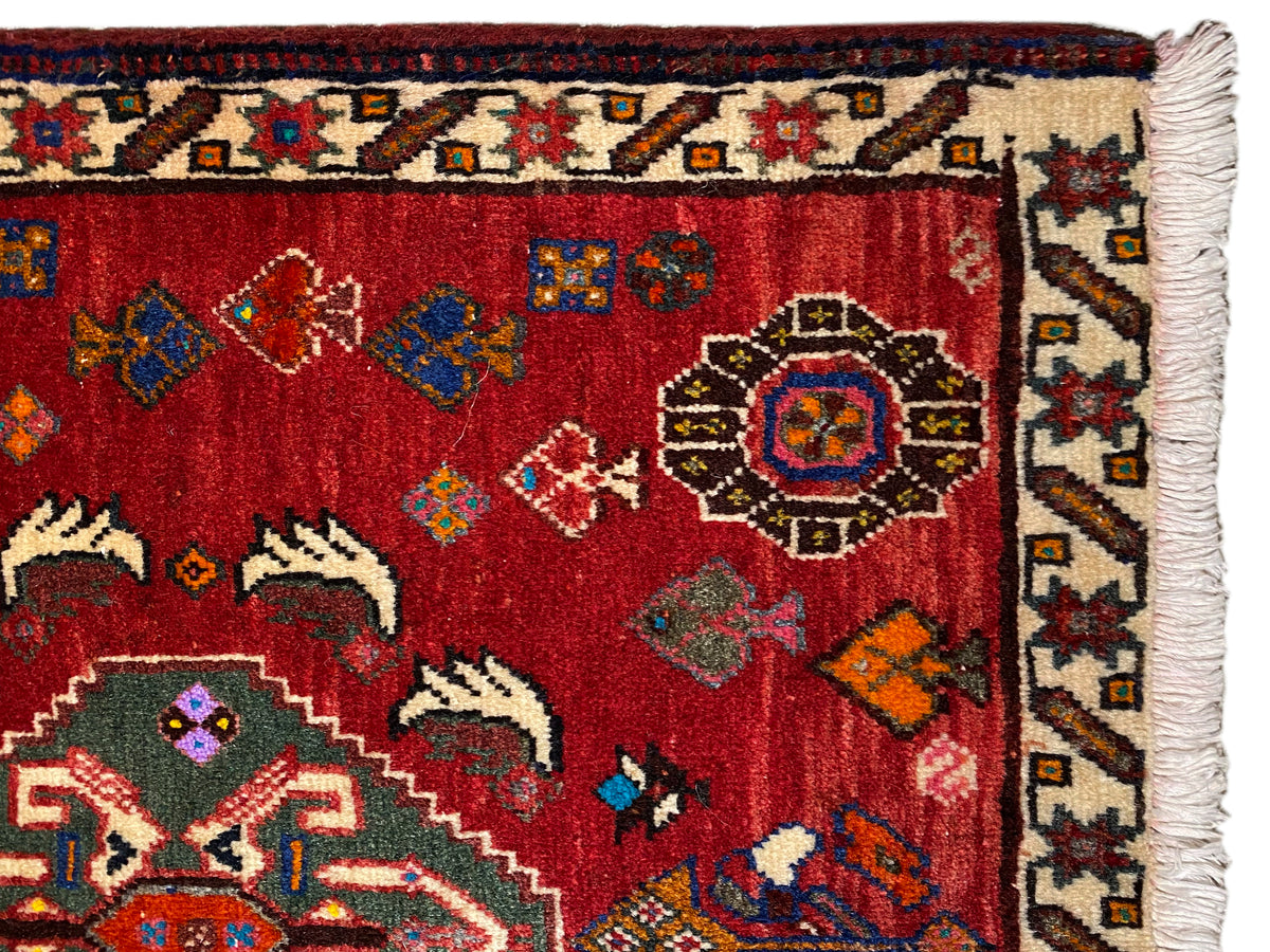 Close-up of Poshti rug, 58x57 cm: red pile with ornaments and fringed edge