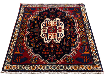 Poshti rectangular rug with a blue background and symmetrical ornamental pattern
