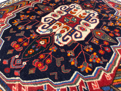 Poshti rug close-up: central white pattern on a dark blue background