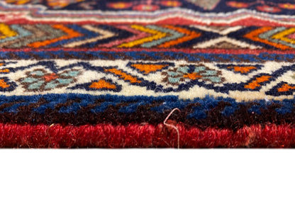 Poshti carpet close-up of the edge with dense pile and a red border