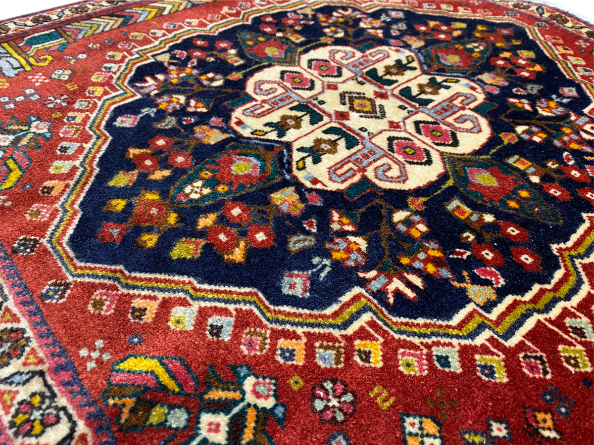 Poshti rug detail: central cross motif with colorful decorative ornaments