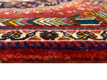 Poshti rug edge detail with red and blue fringes and woven patterns