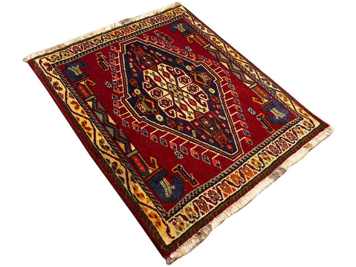 Poshti rug (59×61 cm), spread diagonally, red geometric pattern with fringes