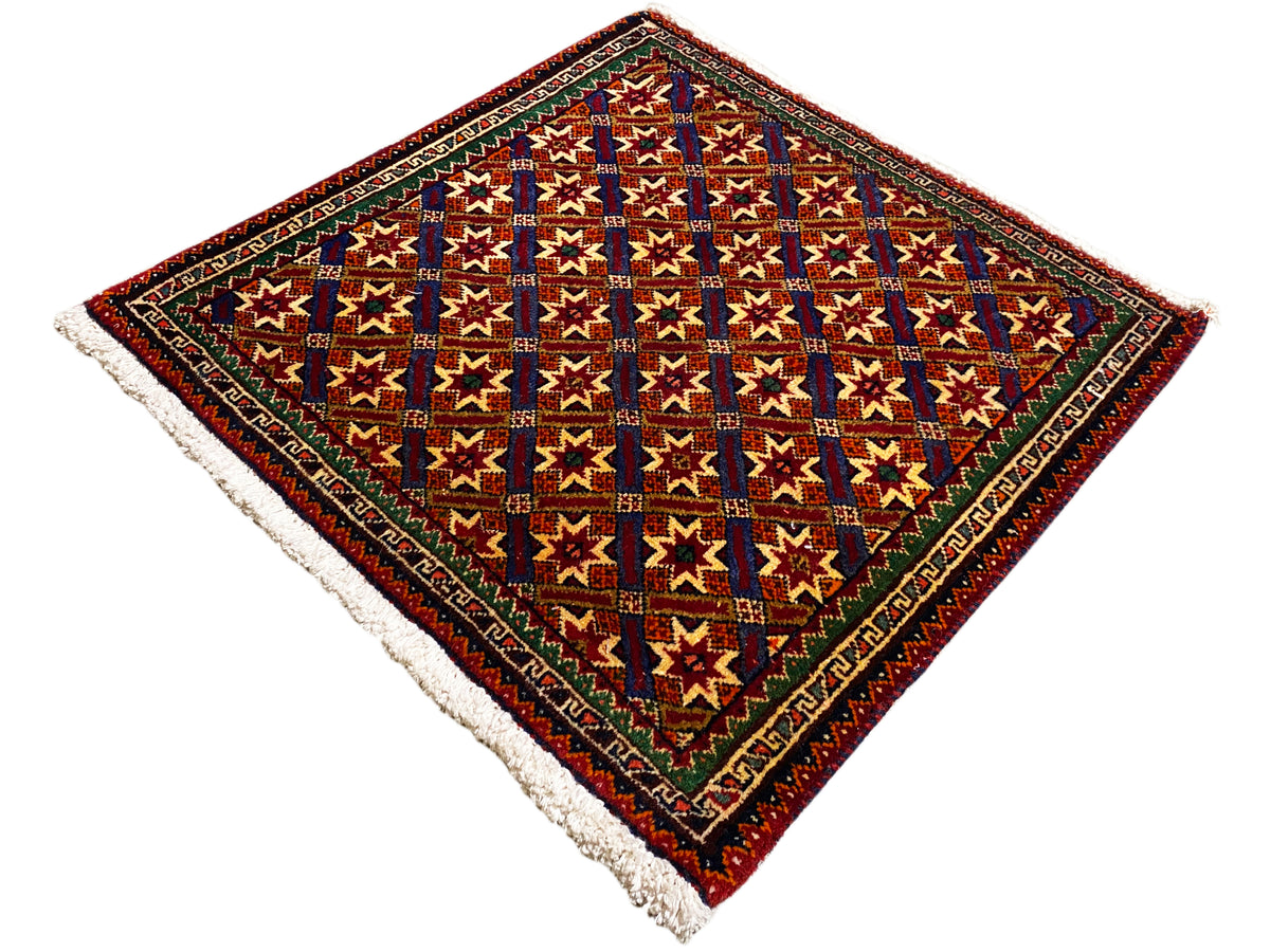 Poshti rug 62x52 cm, detail view: colorful squares and stars, dark border, fringes.