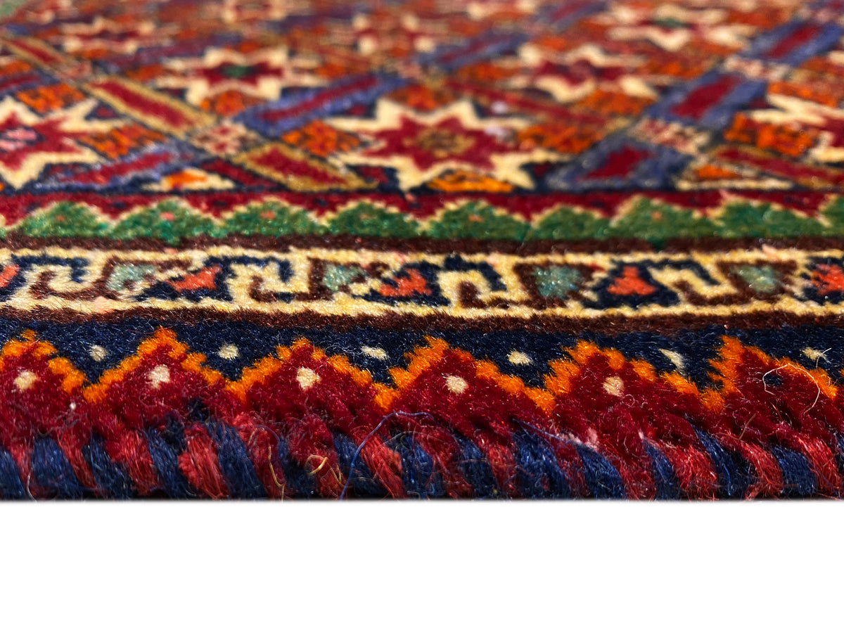 Poshti rug 62x52 cm close-up: colored stripes and high-pile fringes.