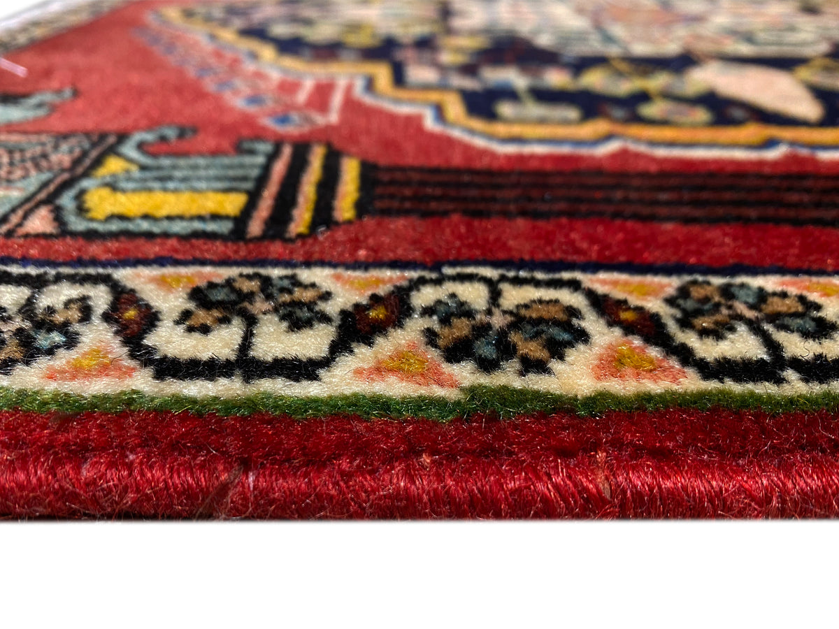Poshti rug with red pile and colorful ornaments along the border