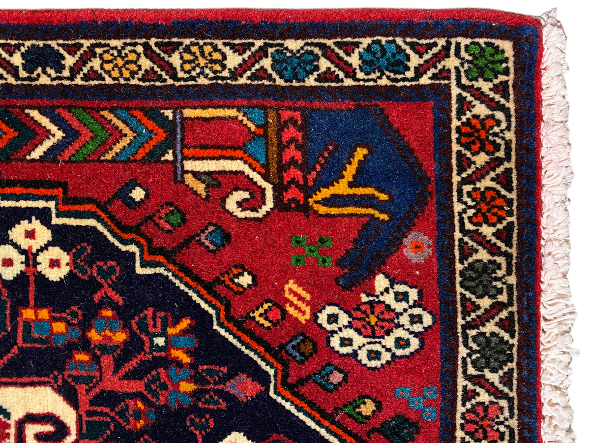 Carpet corner with a colorful border pattern in red, blue, green, and beige