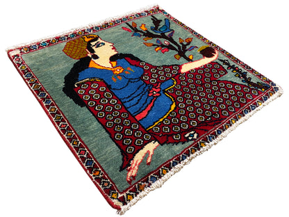 Poshti rug 68x63 cm, angled view from above: figure motif with tree, colored border, fringes