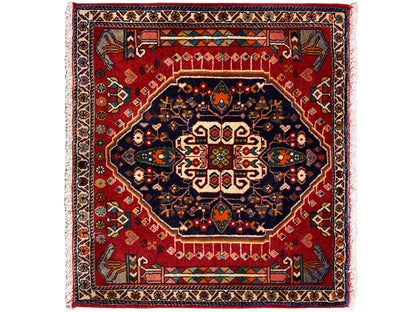 Rug with a red background, dark blue medallion, and multicolored border, square