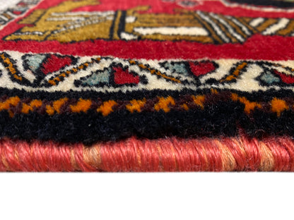 Poshti rug 63x55 cm: Detail of the rug edge with fringes, black border, and red pile