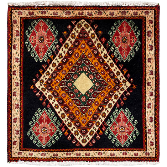 Poshti rug in a rectangular format with a black background, a central diamond pattern, and colorful medallions