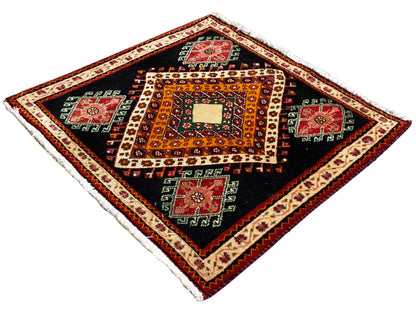 Poshti rug with diamond angles, a black background, a central white diamond, and a colorful border