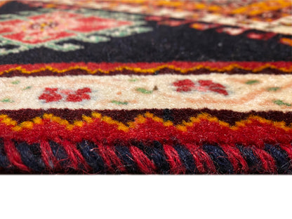 Poshti rug edge detail: multicolored border and dark fringes