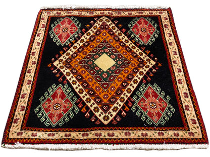 Square Poshti rug with a black ground, central diamond composition, and surrounding decorative border