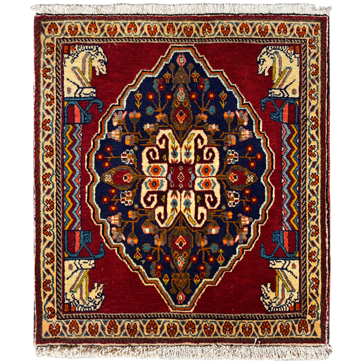 Square rug with a red background, blue medallion, and beige border elements