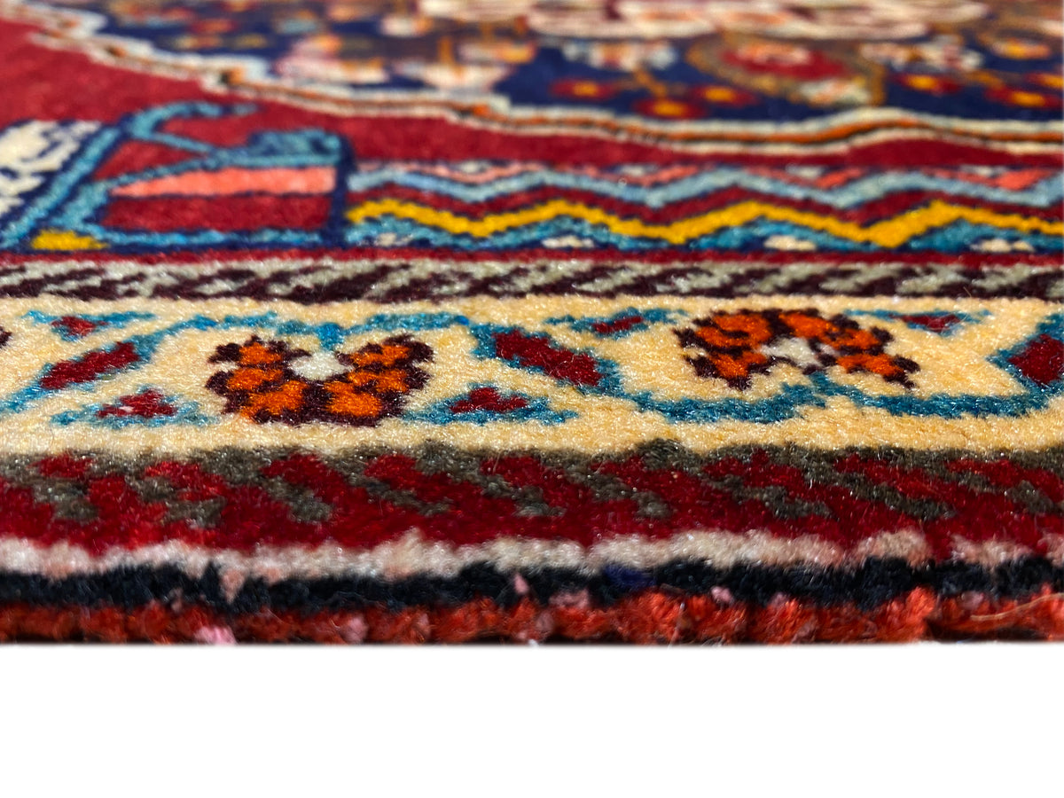 Close-up of carpet detail: colored border, multicolored ornaments, and thick pile texture