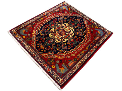Square 67x60 cm rug, red field with a dark blue border and yellow-gold details