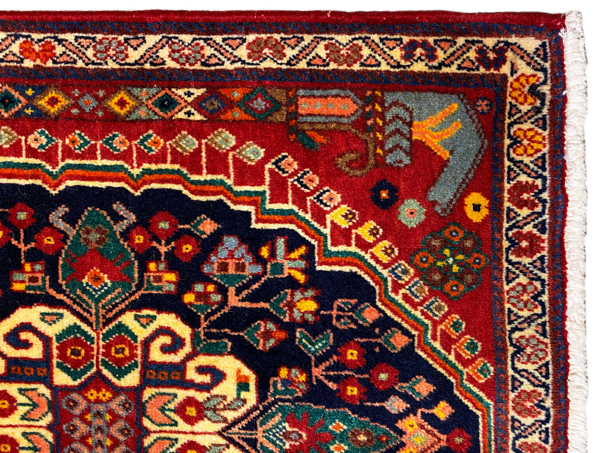 Carpet detail: colorful ornament in the dark blue area with a red background
