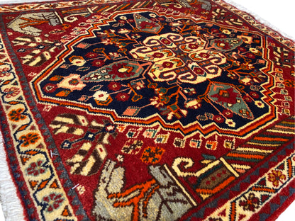 Rug 65x59 cm close-up: central ornamental field in blue, red, and gold tones