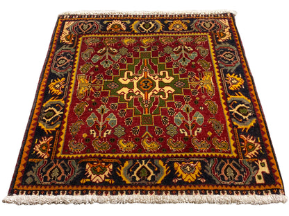 Rug with a red central field, geometric ornaments, and a short fringe border