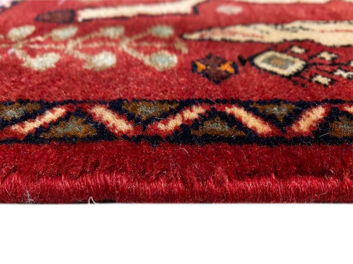 Red Poshti rug detail: pile texture with colorful ornamental bands