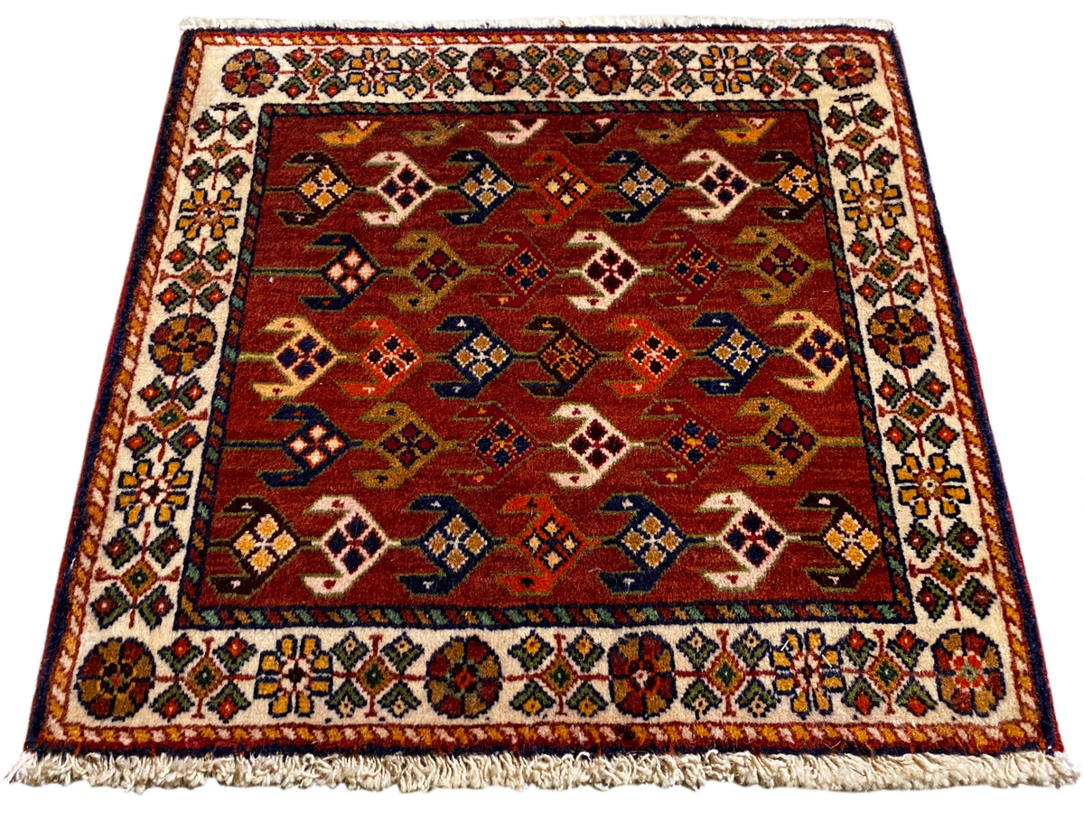 Carpet with a red background, multicolored patterned field and border, fringes along the edge