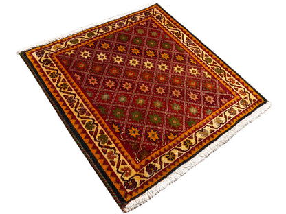 Poshti rug, rectangular, diagonal view: red central field with star patterns and border.