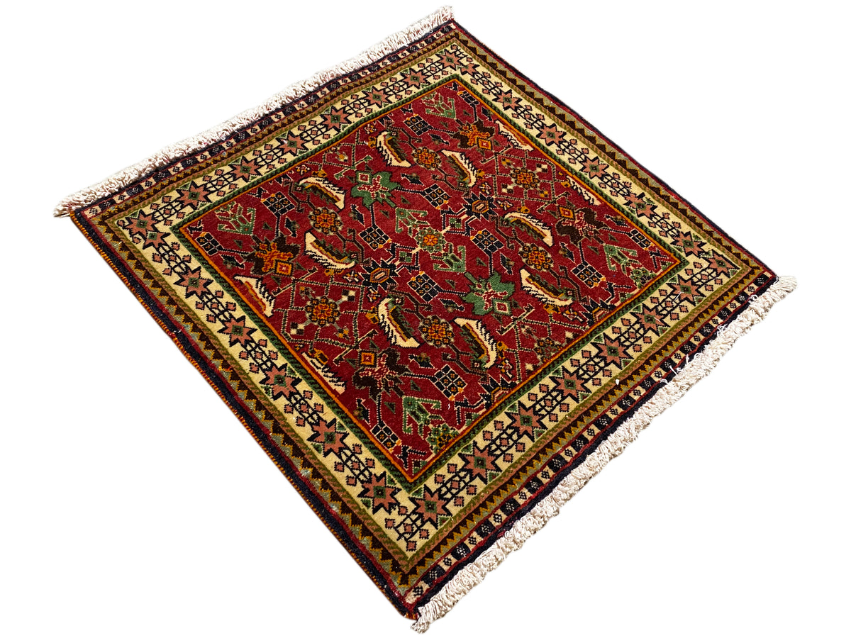Poshti rug 63x61 cm, diagonal view: red pattern with green details, fringe.