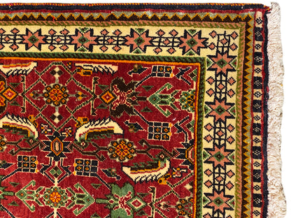Poshti rug 63x61 cm detail view: red ornamental field with green and yellow motifs.