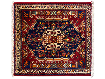 Dark blue 63x60 cm rug with red pattern, border stripes, and fringes