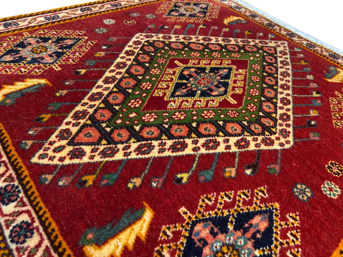 Poshti rug detail: red pattern with a colorful medallion and surrounding border
