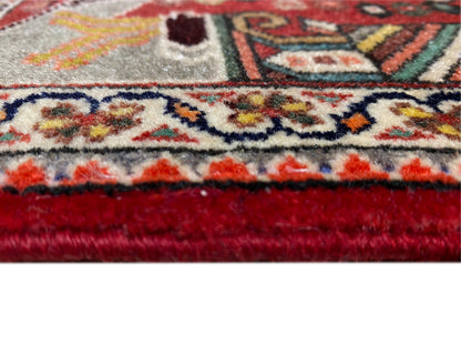 Close-up: carpet edge with fringe, red trim, and a dense ornamental pattern