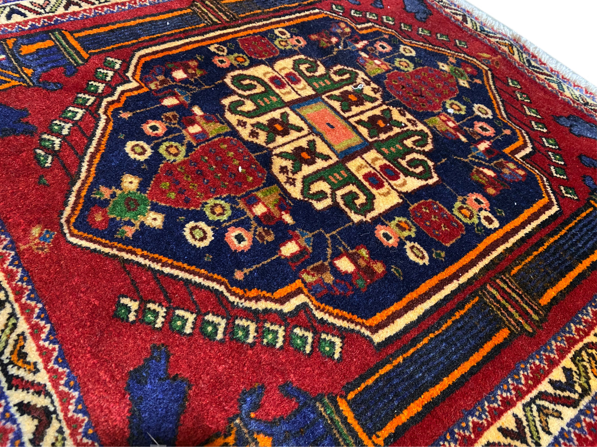 Poshti rug 66x62 cm Detail: red central pattern, blue field, and colorful decorative lines.