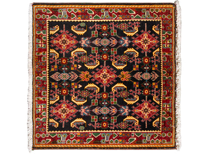 Rug with a square ornamental pattern, black as the base, with shades of red, yellow, and green