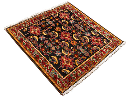 Rug with a diamond pattern, black with shades of red, orange, yellow, and green, hemmed
