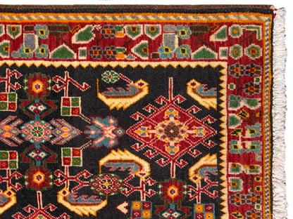 Carpet edge with a colorful border pattern, black, red, green, and yellow areas
