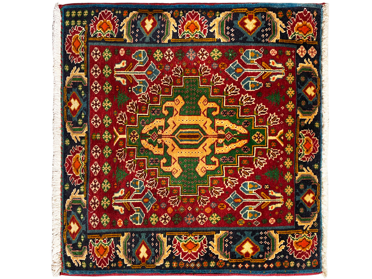 Rectangular rug (67x66 cm) with a red background and dark border trim, geometric pattern