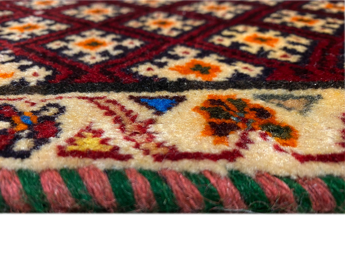 Poshti rug 61x59 cm: Detail of the pile texture and multicolored border, with fringes